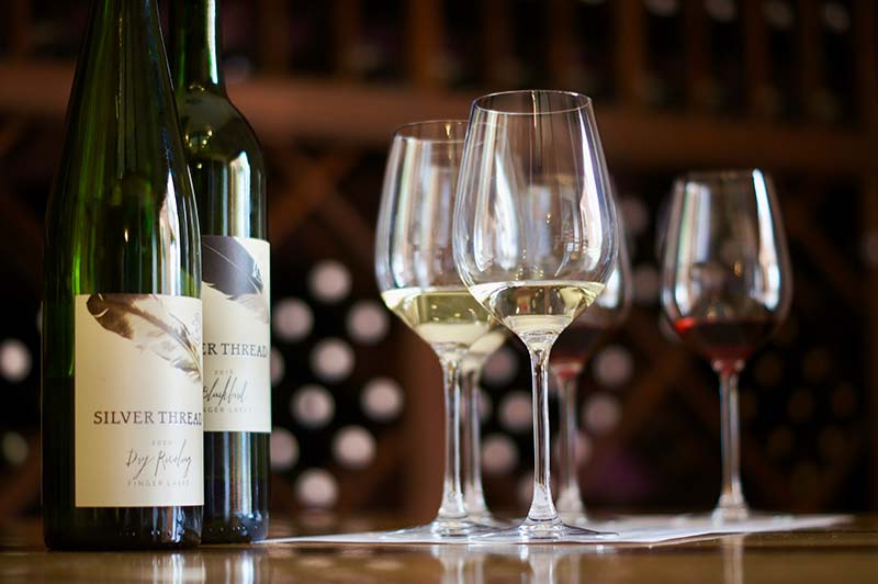 Bottles and glasses of wine on a table.