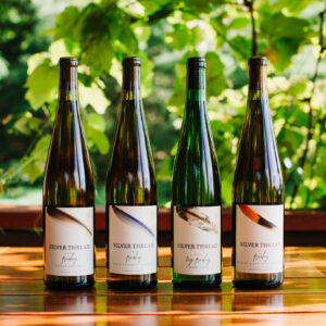 four bottles of Riesling on a table