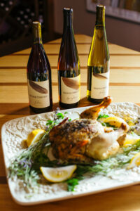 wine bottles with roasted chicken