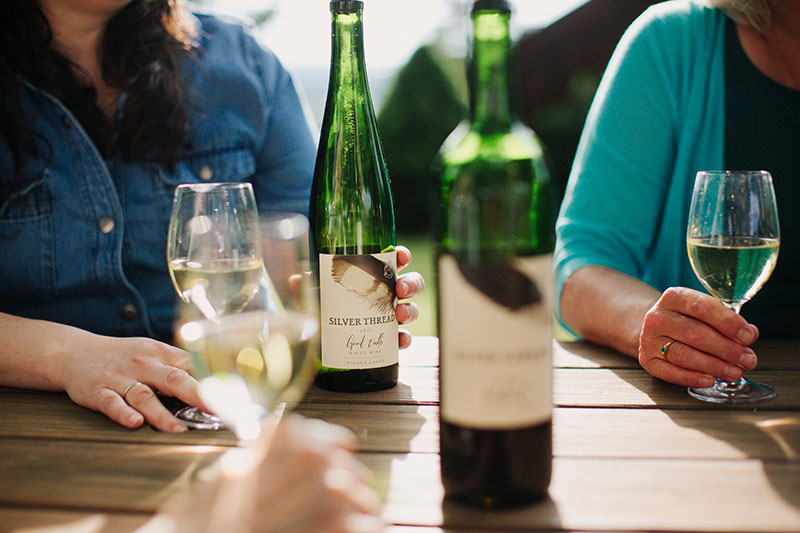 Bottles and glasses of wine on a table.