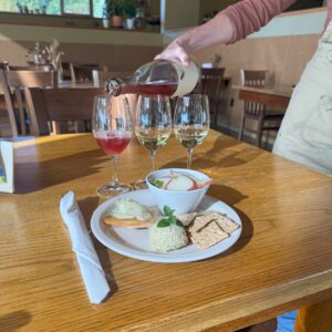 Sparkling wine being poured in to a glass at a table.