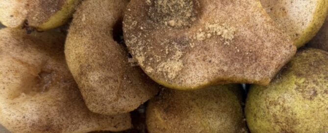 Halved pears with spices on top.